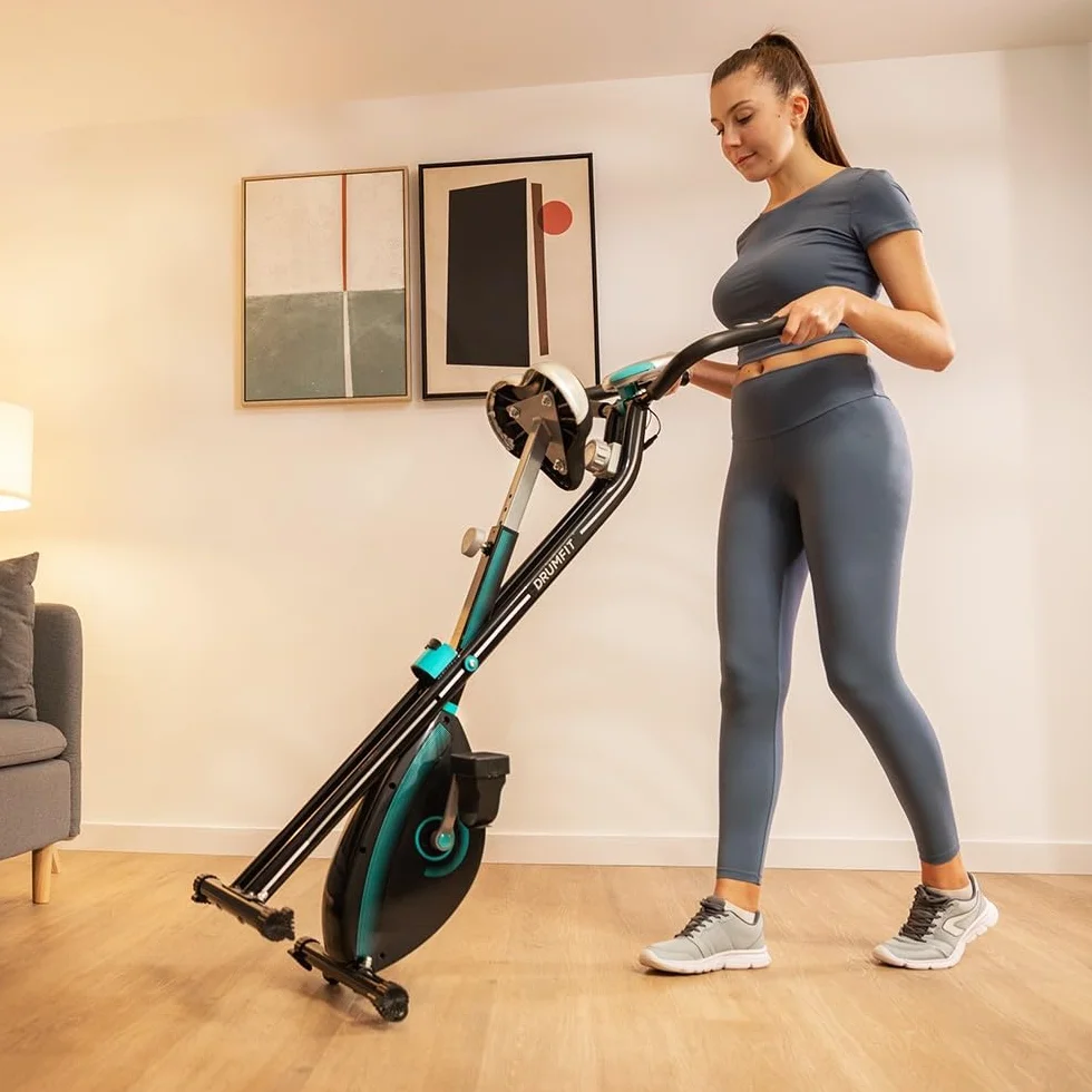 Cecotec Bicicleta estática plegable DrumFit X-Bike Neo, Sillín y manillar lateral, Sistema de plegado fácil y compacto, Soporte para dispositivos, 8 niveles de resistencia, 1,5 Kg volante de inercia.
